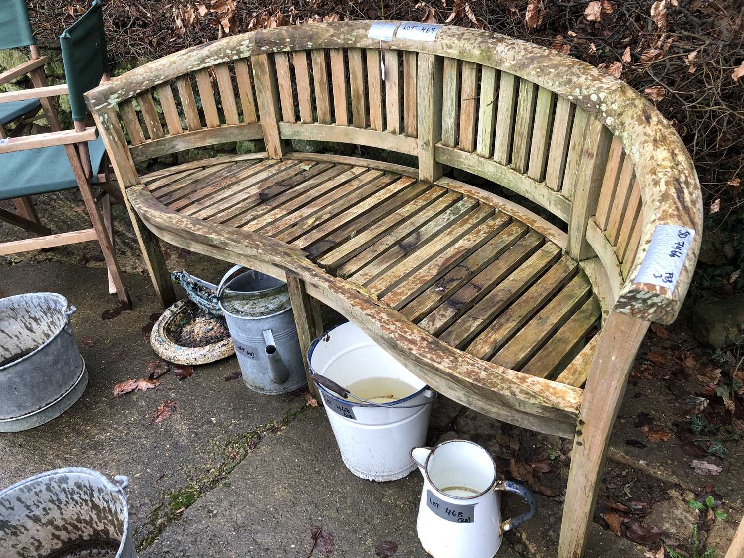 Lot 469 - A wooden garden bench in a bow fronted