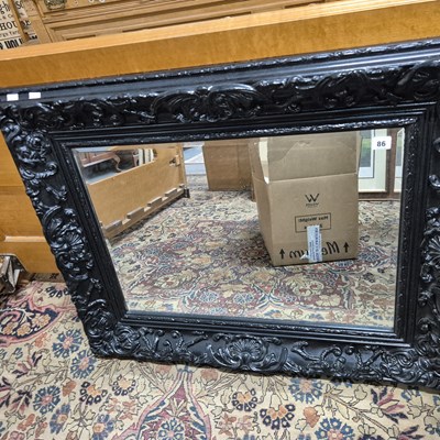Lot 86 - A large black framed wall mirror