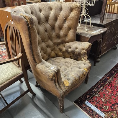 Lot 98 - A button leather barrel back wing armchair for...