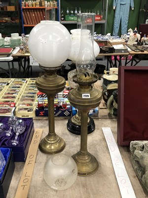 Lot 709 - Three brass and glass oil lamps