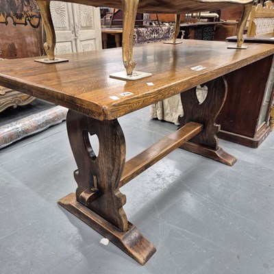 Lot 238 - An oak trestle end table in the Arts and...