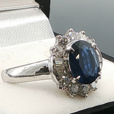 Lot 1065 - A platinum 900 cluster ring set with a central...