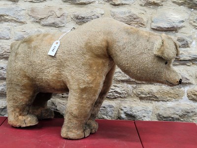 Lot 1142 - An early 20th century plush bear standing on...