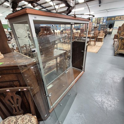 Lot 318 - A large glazed display cabinet with twin doors...