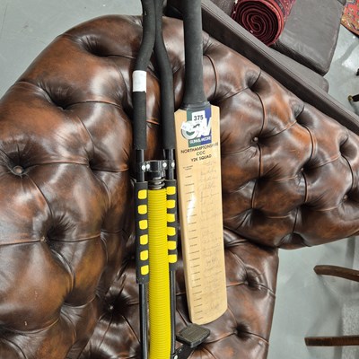 Lot 375 - A signed cricket bat and a pogo stick