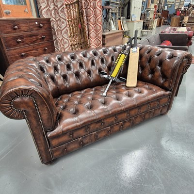 Lot 376 - A brown leather button upholstered...