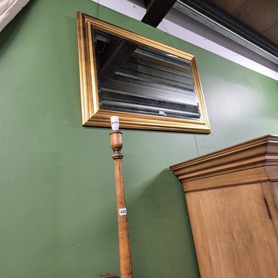 Lot 432 - A gilt-framed wall mirror and an oak standard...
