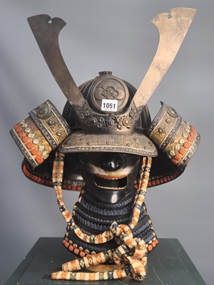 Lot 1051 - A Japanese black lacquer and metal winged...