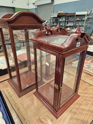 Lot 565 - A pair of glazed mahogany table top cabinets
