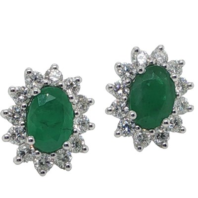 Lot 1099 - A pair of white gold oval emerald and round...