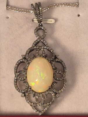 Lot 1101 - Large silver ornate pendant set with an oval...