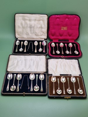 Lot 1077 - Four cases of six silver tea spoons and two...