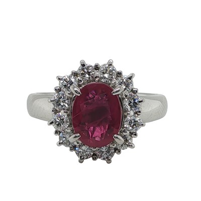 Lot 1113 - A platinum cluster ring set with an oval...