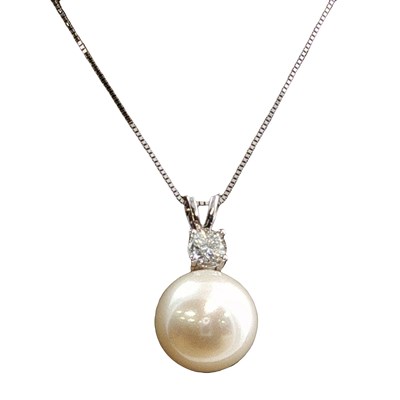 Lot 1124 - A 9ct white gold pendant set with a round...