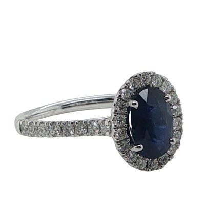 Lot 1126 - A 9ct gold oval blue sapphire ring set with...