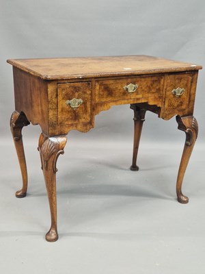 Lot 1309 - A mid 18th century walnut lowboy, the cross...