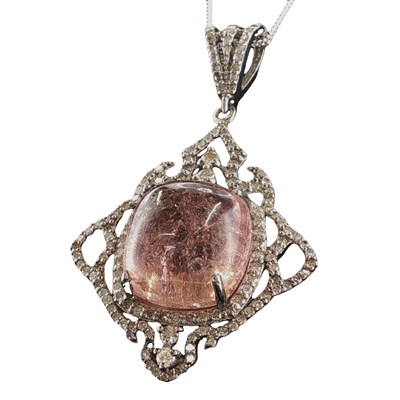 Lot 1137 - An unusual and ornate silver pendant set with...