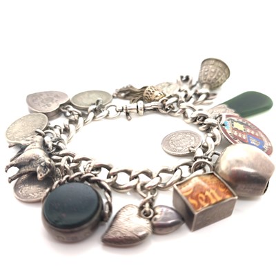 Lot 1139 - A vintage silver charm bracelet and attached...