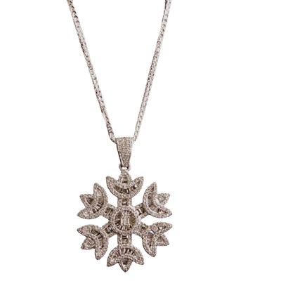 Lot 1149 - A 9ct white gold snowflake pendant set with...