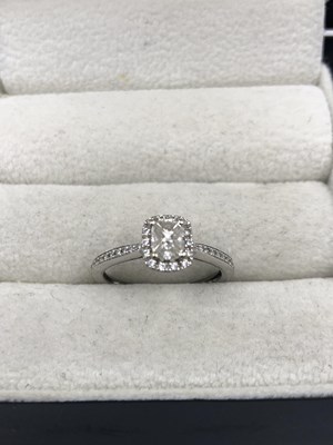 Lot 1160 - An 18ct hallmarked white gold and diamond ring....