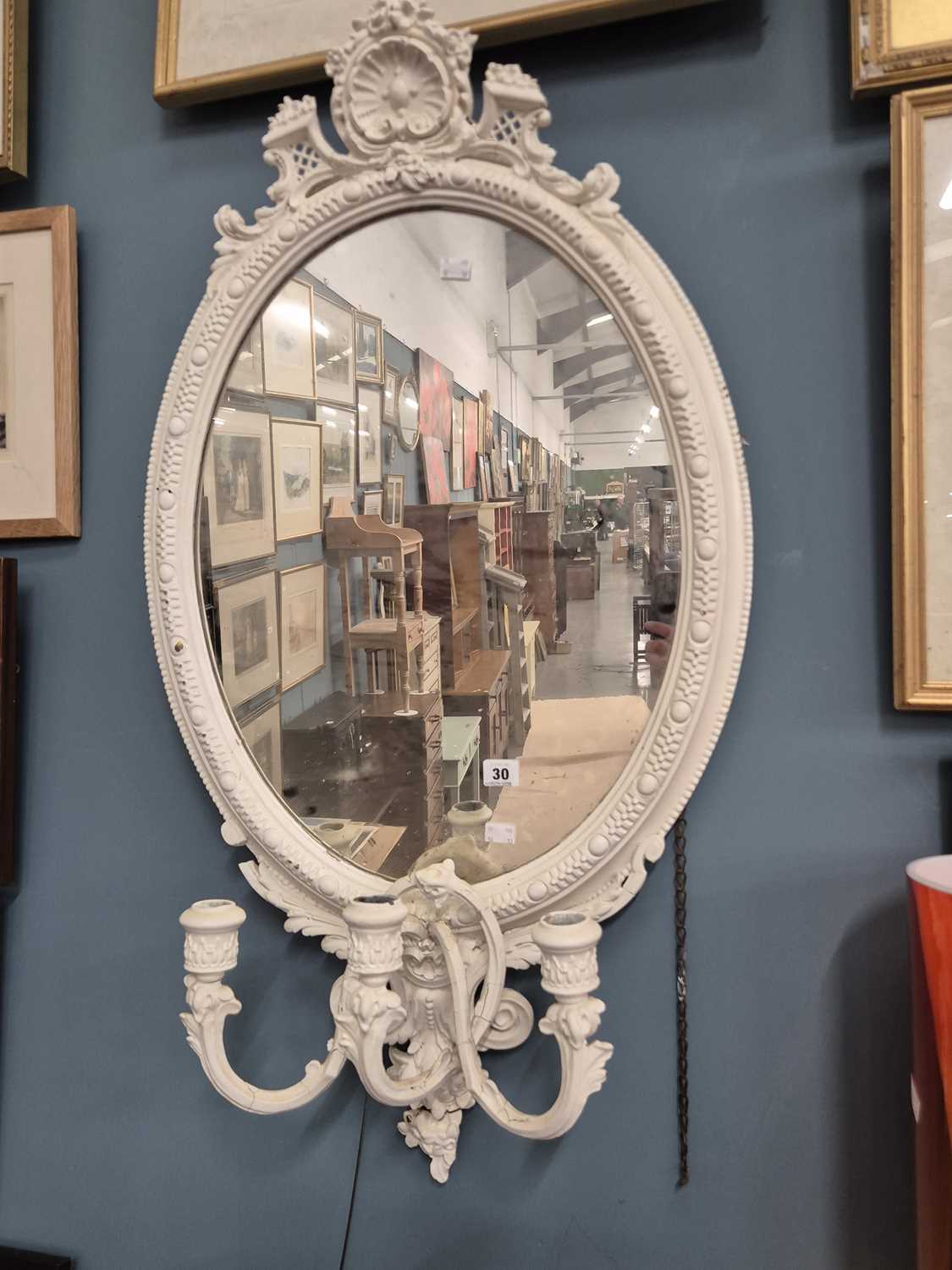 Lot 30 - An antique wall mirror with a light candle sconce