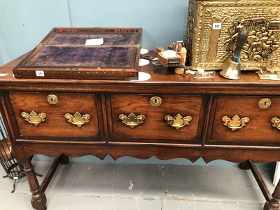 Lot 57 - A Georgian-style oak three-drawer dresser base...
