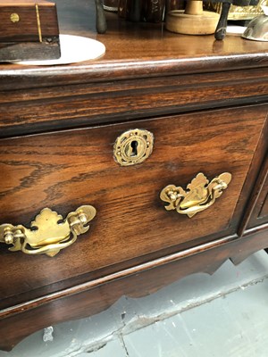 Lot 57 - A Georgian-style oak three-drawer dresser base...