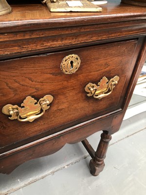 Lot 57 - A Georgian-style oak three-drawer dresser base...