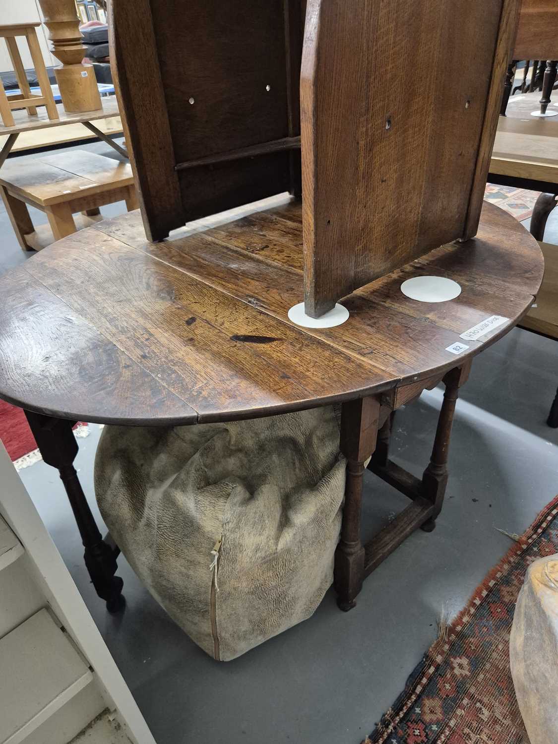 Lot 82 - An 18th-century oak cottage gateleg supper...