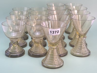 Lot 1372 - A set of nine green glass rummers with conical...