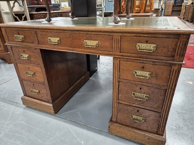 Lot 123 - An early 20th century oak twin pedestal...