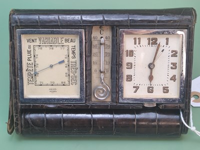 Lot 1390 - A faux crocodile cased travel clock, mercury...