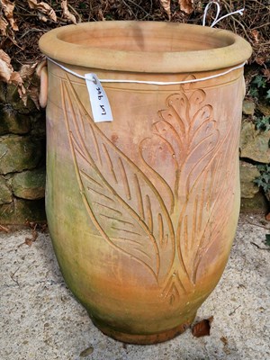 Lot 946 - A large terracotta garden urn with a floral...
