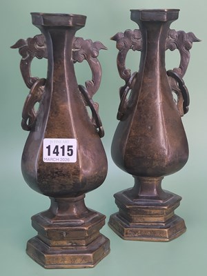 Lot 1415 - A pair of Ming two handled bronze vases raised...