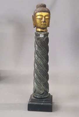Lot 1433 - A gilt stone head of the Buddha raised of...