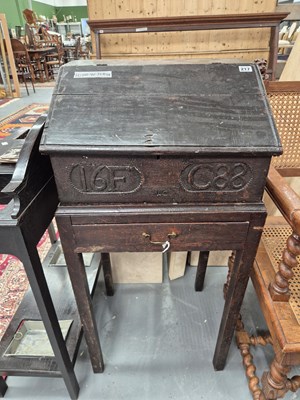 Lot 217 - A 17th-century oak slope top clerk's desk or...