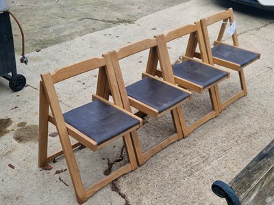 Lot 979 - A set of four teak folding garden chairs with...