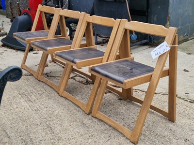 Lot 979 - A set of four teak folding garden chairs with...