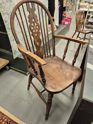 Lot 328 - A set of four wheel back dining chairs