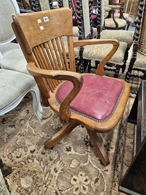 Lot 351 - An antique oak swivel office chair