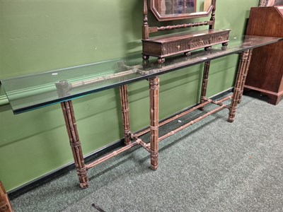 Lot 363 - A glass-topped bamboo hall table. W 241 D 46 H...