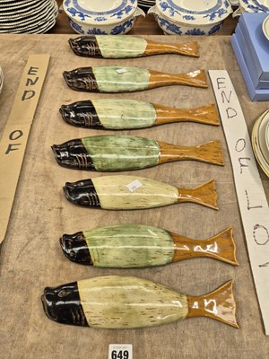 Lot 649 - A set of six pottery fish wall ornaments