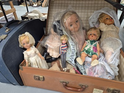 Lot 670 - Two suitcases and a quantity of dolls