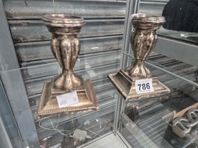 Lot 786 - A pair of silver metal candlesticks
