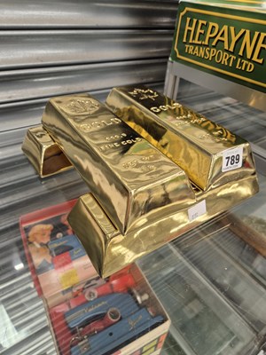 Lot 789 - Four large decorative gold-coloured 'bullion'...