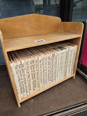 Lot 809 - A set of Beatrix Potter books in a desk top...