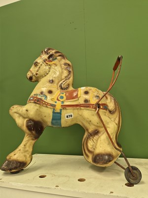 Lot 870 - A tinplate push-along horse toy, probably by...