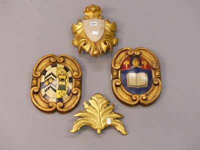 Lot 1231 - Two painted armorials in similar gilt scroll...
