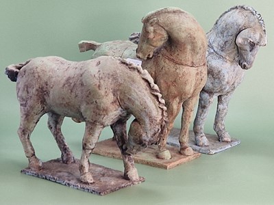 Lot 1013 - Three bronzed pottery Tang style horses...