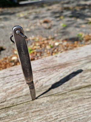 Lot 31 - Named and personal. This small folding silver...